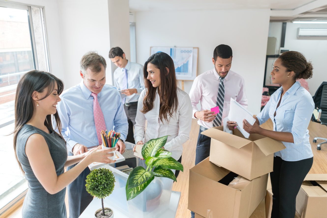 people safely packing office equipment